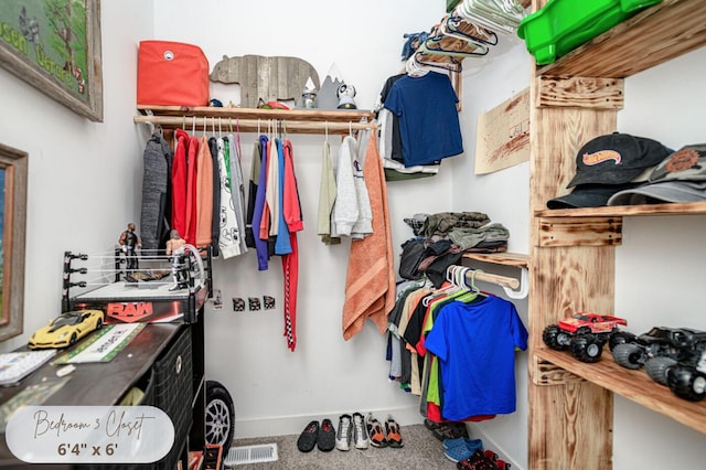 walk in closet featuring carpet