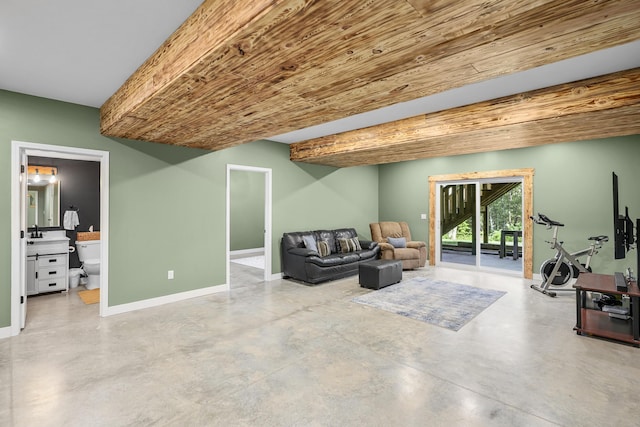 sitting room with concrete flooring, sink, and wood ceiling