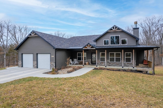 view of front of house featuring a front lawn, a porch, and a garage