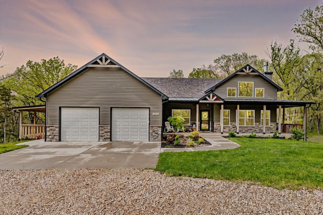 4503 E Mcgee Rd, Columbia, MO 65202 - craftsman house featuring a lawn, stone siding, an attached garage, driveway, and a porch