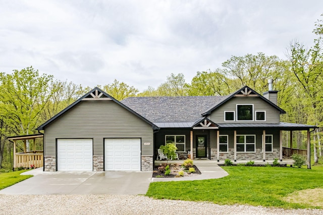4503 E Mcgee Rd, Columbia, MO 65202 - view of front of property with a standing seam roof, concrete driveway, a porch, and stone siding