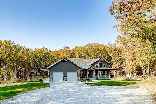 4503 E Mcgee Rd, Columbia, MO 65202 - view of front of home with a front lawn, stone siding, a garage, a porch, and driveway