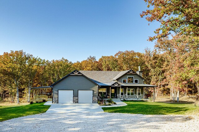 4503 E Mcgee Rd, Columbia, MO 65202 - view of front of house with a garage, a front yard, covered porch, and driveway