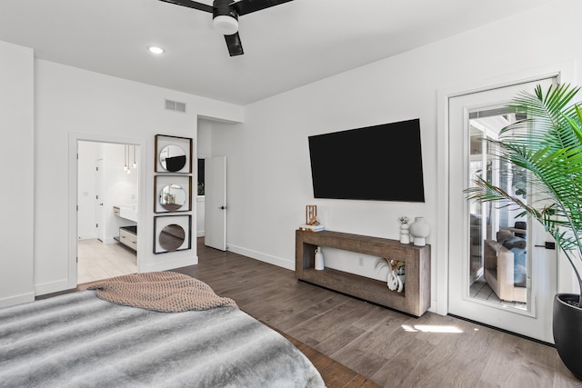 bedroom with visible vents, connected bathroom, wood finished floors, access to outside, and baseboards