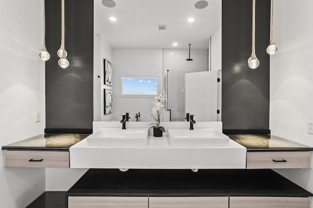 full bathroom with recessed lighting, walk in shower, a sink, and double vanity