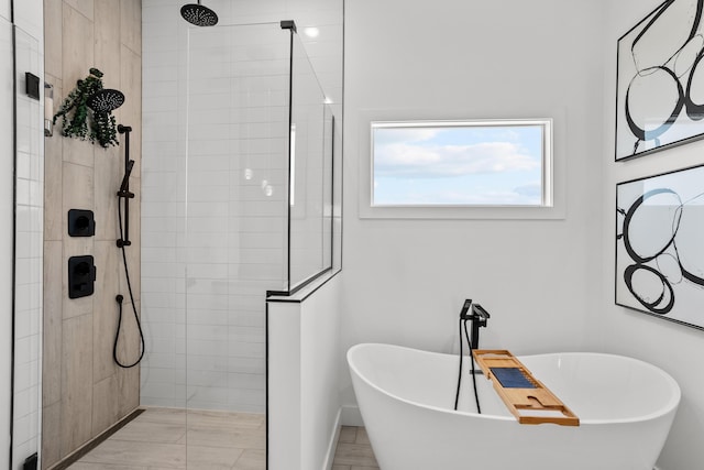 bathroom featuring a soaking tub and walk in shower