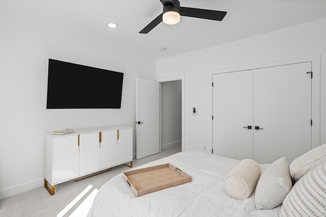 bedroom featuring light carpet, baseboards, ceiling fan, a closet, and recessed lighting