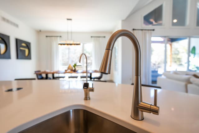 details with light countertops, a sink, and hanging light fixtures