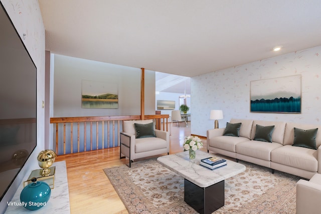 living area with wallpapered walls and wood finished floors