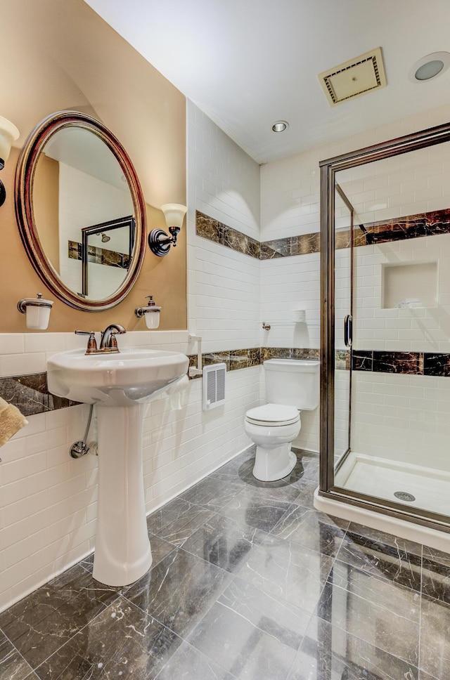 bathroom with visible vents, marble finish floor, toilet, and a shower stall