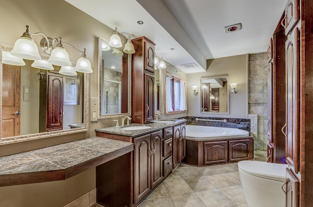 full bathroom with a garden tub, toilet, tile patterned floors, and a sink