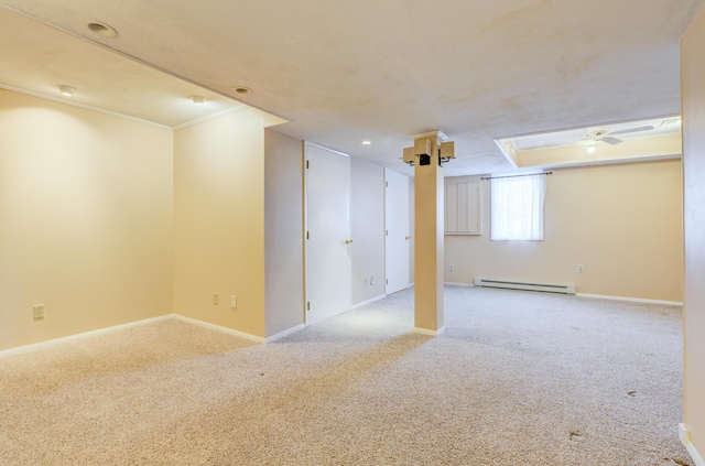 below grade area with baseboards, baseboard heating, ceiling fan, and carpet