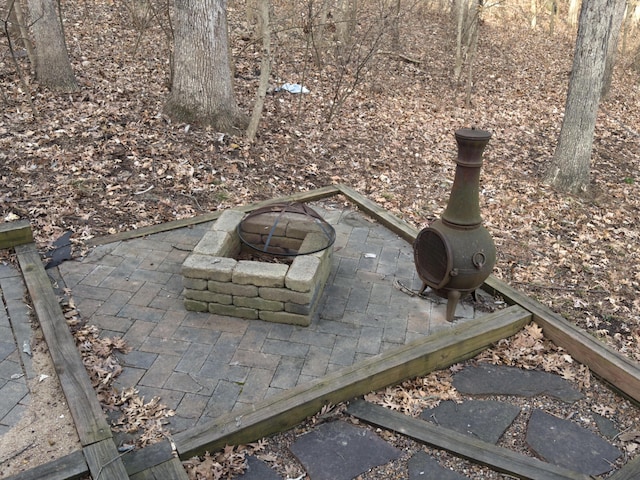 exterior details featuring an outdoor fire pit