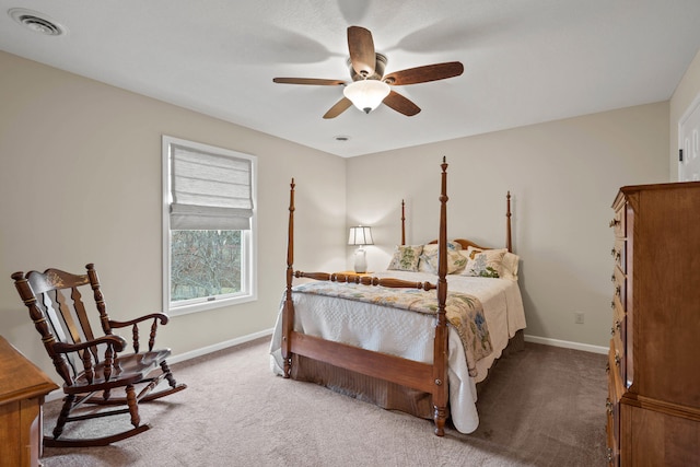 carpeted bedroom featuring ceiling fan, visible vents, and baseboards