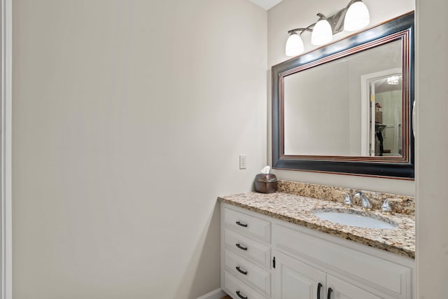 bathroom with vanity and baseboards