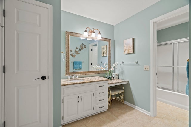 full bath featuring tile patterned floors, baseboards, combined bath / shower with glass door, and vanity