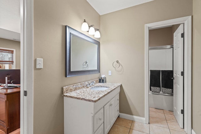 bathroom with vanity, baseboards, and tile patterned floors