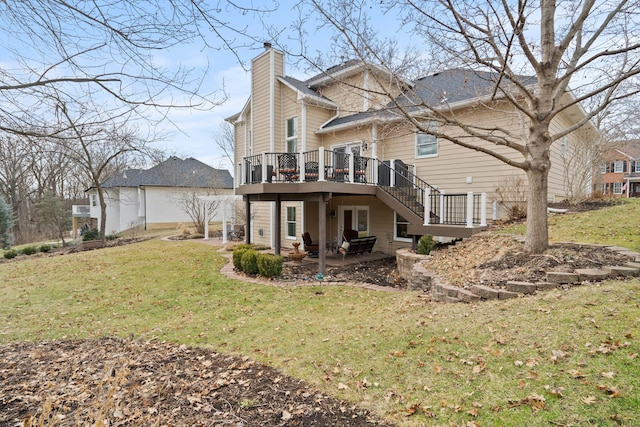 back of house with a chimney, a lawn, a deck, and a patio