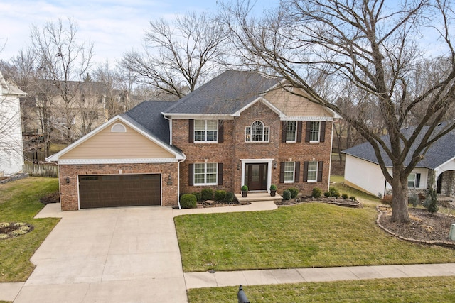 colonial home with an attached garage, driveway, a front yard, and brick siding