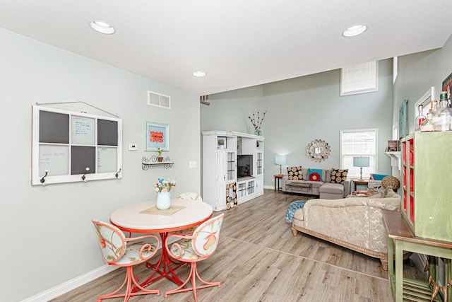 dining room with wood finished floors, baseboards, and recessed lighting
