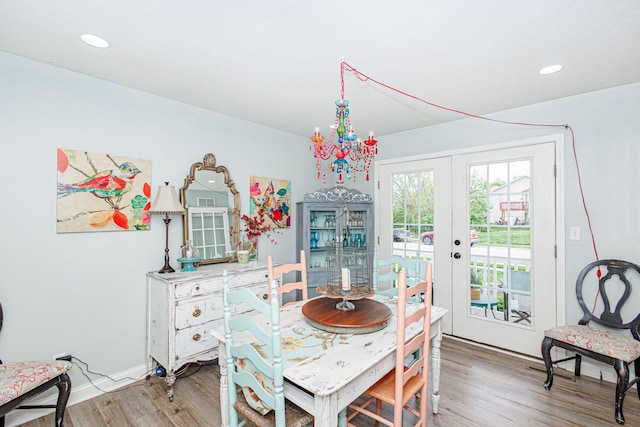 dining area with light wood-style floors, french doors, a chandelier, baseboards, and recessed lighting