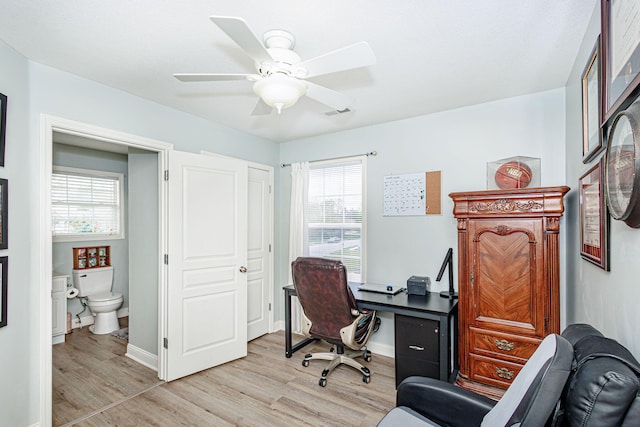 home office featuring light wood-style flooring, healthy amount of natural light, a ceiling fan, and baseboards