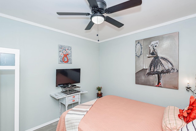 bedroom with crown molding, a ceiling fan, wood finished floors, and baseboards