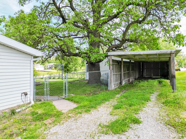60 N Harris St, Harrisburg, MO 65256 - view of yard featuring fence, a detached carport, a gate, and driveway