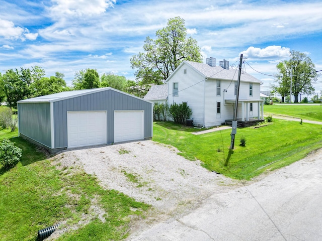 60 N Harris St, Harrisburg, MO 65256 - view of home's exterior with a garage, an outbuilding, a yard, and a chimney