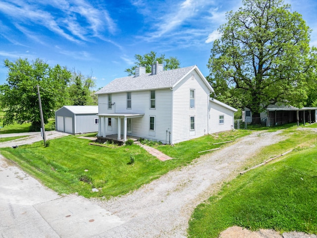 60 N Harris St, Harrisburg, MO 65256 - view of front of house with an outdoor structure, driveway, a chimney, a garage, and a front lawn
