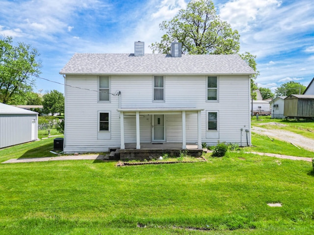 60 N Harris St, Harrisburg, MO 65256 - rear view of house featuring covered porch, a chimney, a yard, and roof with shingles