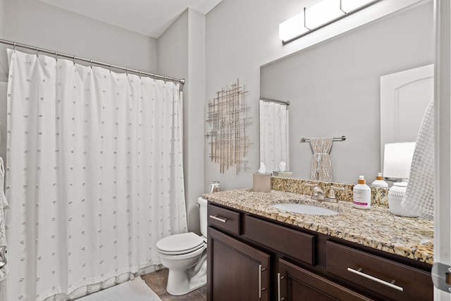 full bathroom featuring a skylight, vanity, toilet, and a shower with curtain