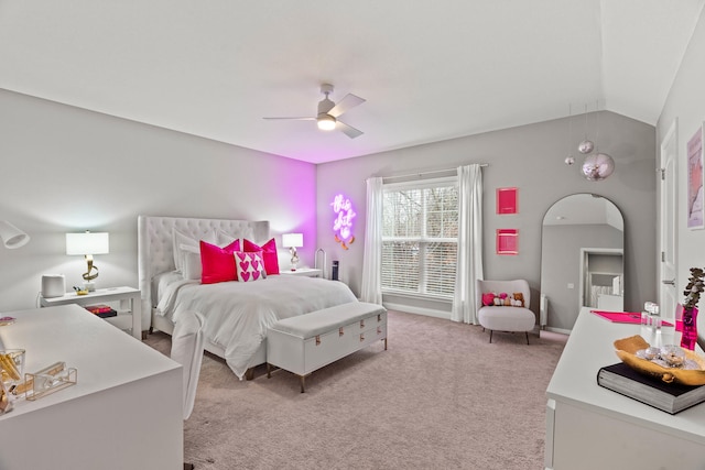 bedroom featuring lofted ceiling, light carpet, and ceiling fan