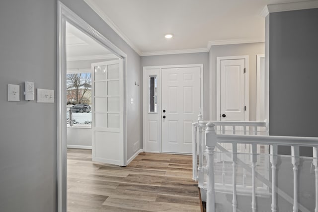 entrance foyer featuring ornamental molding, baseboards, and wood finished floors