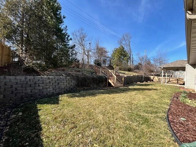 view of yard with stairs and fence