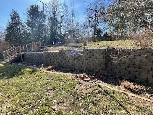 view of yard with stairs and fence