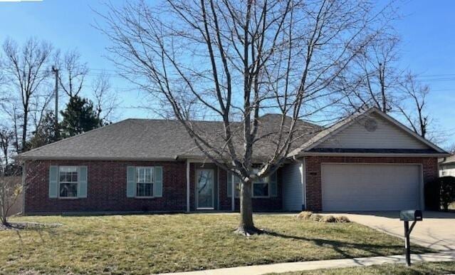 ranch-style home featuring a garage, concrete driveway, a front lawn, and brick siding