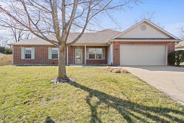 single story home featuring brick siding, driveway, an attached garage, and a front yard