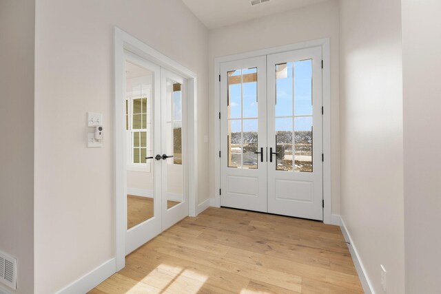 4509 Royal County Rd, Columbia, MO 65201 - entryway with french doors, baseboards, light wood-style floors, and visible vents