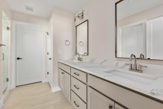 4509 Royal County Rd, Columbia, MO 65201 - bathroom featuring double vanity, a sink, visible vents, and a shower stall