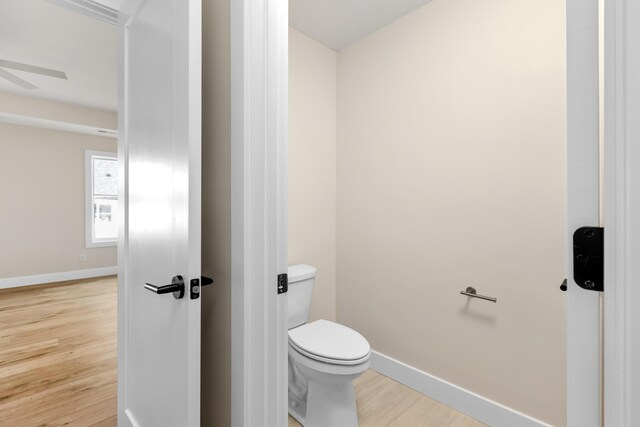 4509 Royal County Rd, Columbia, MO 65201 - bathroom featuring toilet, baseboards, ceiling fan, and wood finished floors