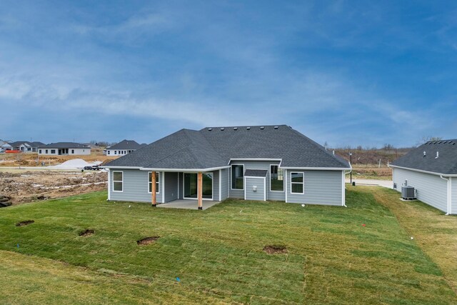 4509 Royal County Rd, Columbia, MO 65201 - rear view of house featuring a lawn, a shingled roof, and a patio area