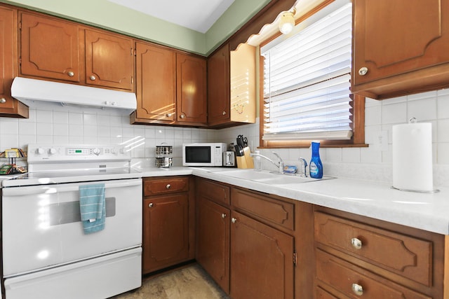 2417 Quail Dr, Columbia, MO 65202 - kitchen with sink, backsplash, and white appliances