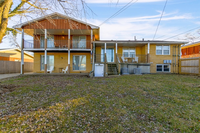 2417 Quail Dr, Columbia, MO 65202 - back of property with central AC unit, a yard, and a balcony