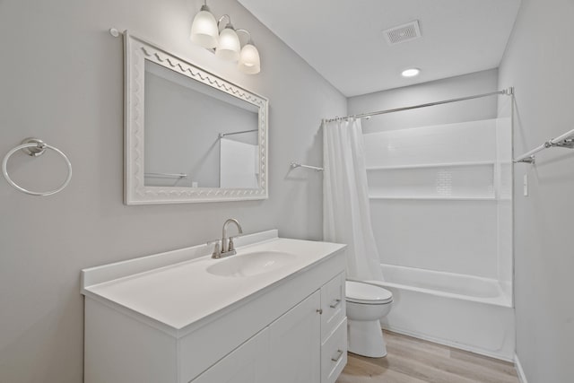 full bathroom featuring shower / tub combo with curtain, vanity, toilet, and hardwood / wood-style floors