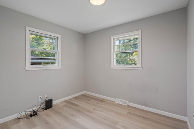 unfurnished room with plenty of natural light and light wood-type flooring