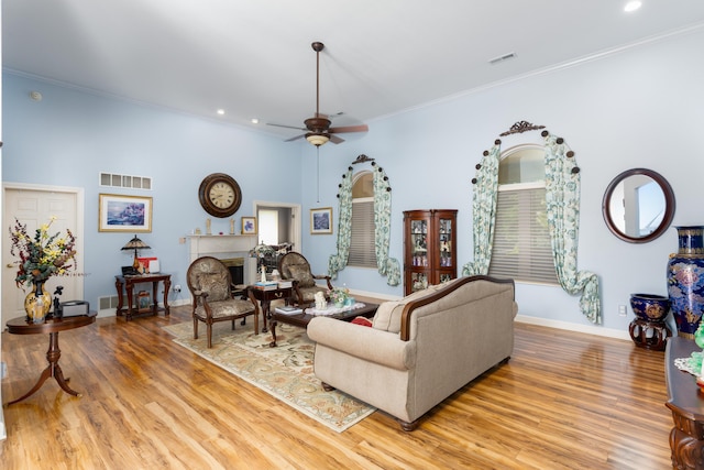 living room featuring ornamental molding, hardwood / wood-style floors, and ceiling fan