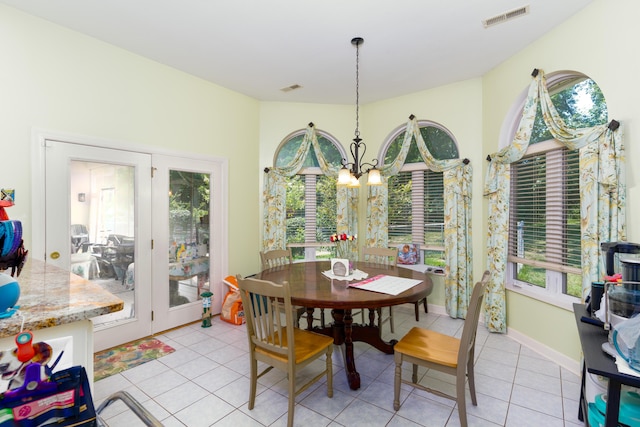 dining room featuring a notable chandelier and light tile patterned floors