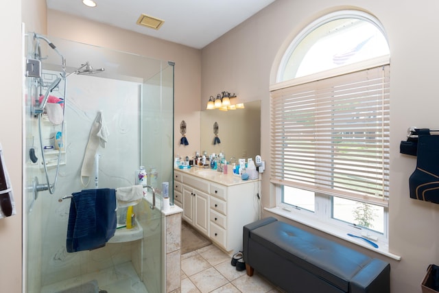 bathroom featuring vanity, tile patterned flooring, and a shower with door