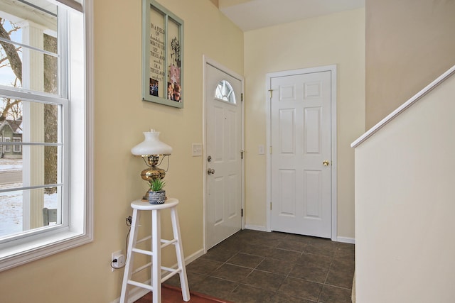 tiled entrance foyer featuring a wealth of natural light